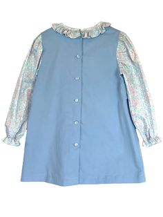 Upgrade your little girl's wardrobe with our Ellie Apron Sweet Meadow Blue Floral Dress. This darling corduroy dress is perfect for fall and winter, featuring side tabs. The built-in ruffled collar blouse with puff sleeves adds an extra touch of cuteness. Get ready to turn heads with this adorable dress! Blouse With Puff Sleeves, Style Bubble, Bloomers Shorts, Blue Floral Dress, Street Kids, Bubble Dress, Apron Dress, Ruffled Collar, Corduroy Dress