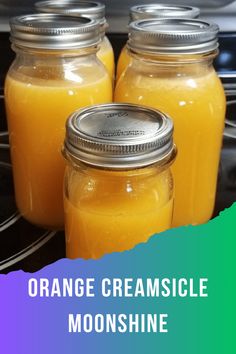 three jars filled with orange creamsice sitting on top of a stove next to each other