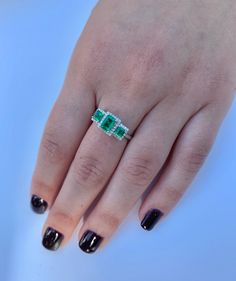 "Pacific Jewelry Presents, 3 Emerald cut natural Colombian Emeralds paired together in a vintage 18k white gold setting and adorned with 0.19 carats of round cut diamonds. ✔ Gold Karat: 18K ✔ 3 Emeralds: 1.03 carat total weight ✔ Round Diamond: 44 pieces, 1 MM, 0.19 carats ✔ Zero degree of clarity enhancement ✔ Emerald origin: Muzo mine, Colombia ✔ Ring Size: 7 1/2 U.S. SHIPPING TIMES USA: 4-12 business days (USPS) Canada: 5-14 business days Australia: 5-12 business days (Australia Line) New Zea White Gold Emerald Ring With Three Stones, Elegant White Gold Emerald Three Stone Ring, 14k White Gold Three Stone Jewelry, Three Stone Emerald White Gold Ring, White Gold Emerald Three Stone Ring, Platinum Emerald Three Stone Ring For Anniversary, Elegant Sterling Silver Emerald Three Stone Ring, Elegant White Gold Emerald Ring With Three Stones, Elegant Three Stone Emerald Ring In White Gold