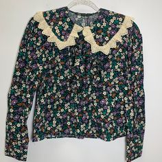 Size M Pit To Pit 19 Inch Nwt Zara Floral Printed Blouse With Ruffle And Lace Trim Adorable Floral Printed Blouse With Lace Trim Peter Pan Collar And Tie At Neck. Long Sleeves.Embroidery Cottagecore Cute Vintage Vibes 70s 90s 80s Preppy Work Office Zara Floral Print Cotton Blouse, Green Floral Print Top With Collar, Zara Cotton Blouse With Floral Print, Zara Floral Print Collared Blouse, Zara Collared Blouse With Floral Print, Vintage Green Tops With Ruffles, Fitted Floral Print Top With Peter Pan Collar, Floral Print Tops With Peter Pan Collar For Daywear, Retro Long Sleeve Blouse With Lace Collar