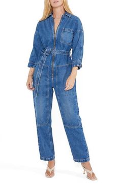 With a classic blue wash, this belted jumpsuit with a zip-front closure and plethora of pockets is a stylish way to make an all-denim statement. Point collar Three-quarter sleeves 77% cotton, 23% Tencel® Refibra™ lyocell Tencel Refibra lyocell is a sustainably produced fiber made from wood pulp and recycled cotton scraps using closed-loop processing Machine wash, line dry Imported Denim Jumpsuit For Work With Belt Loops, Casual Denim Jumpsuit With Belt Loops For Work, Belted Denim Jumpsuit For Workwear, Denim Belted Overalls Jumpsuits And Rompers, Utility Style Dark Wash Jumpsuits And Rompers For Fall, Chic Denim Belted Jumpsuits And Rompers, Spring Denim Jumpsuit For Work With Belt Loops, Denim Jumpsuit With Belt Loops For Workwear In Spring, Spring Denim Jumpsuit With Belt Loops For Work