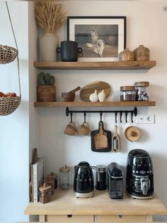 the shelves are filled with coffee cups and other kitchen items