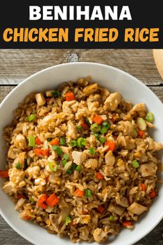 chicken fried rice in a white bowl with carrots and celery on the side