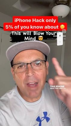 a man wearing glasses and a hat pointing at the camera with an ad on his phone