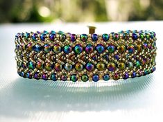 "Mardi Gras Beaded Cuff Bracelet This cuff bracelet has so many colors I couldn't list them.  I has some \"haft\", so when you wear it, you will want to show it off.  The double flat weave design is eye catching in itself.  I used a slide closure to secure it. I use a spider wire so I can secure the beads over and over to assure this creation will be around for a long time.   Matching earrings are coming. Let us make something beautiful for you today!" Mardi Gras Beads, Beaded Cuff Bracelet, Beaded Cuff, Bracelet Cuff, Bracelet Beaded, Bead Patterns, Colorful Bracelets, Bracelet For Women, Bead Weaving