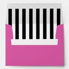 a pink envelope with black and white stripes on the front, in an open position