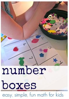 a child's hands are on top of a number box