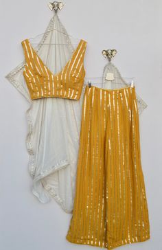 This is a made to measure piece!  Price includes blouse, trousers and dupatta. There are three blouse options: 1. A matching yellow blouse with high neck and open back, with a tie up mirror latkan fastening. 2. An off white silk blouse with a gold sequin trim, plunge neckline and hook and eye fastening at the back. 3. A matching yellow plunge neckline blouse with vertical stripes, and a Hooke and eye fastening at the back. The trousers are high waisted and wide legged, it's made from a sequin em Vertical Lines Blouse Designs, Fitted Pant Set With Sheer Dupatta, Yellow Palazzo Set With Dupatta For Reception, Fitted Yellow Palazzo Set For Reception, Yellow Georgette Palazzo Set For Reception, Yellow Mirror Work Sets For Reception, Yellow Sets With Mirror Work For Reception, Elegant Yellow Sets For Navratri, Fitted Yellow Georgette Palazzo Set