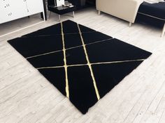 a black and gold rug on the floor in a living room