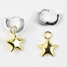 CZ accents Gold and silver plating over brass Post earring with hinged hoop Earrings measure about 1.25" long Star is removable Made in Mexico Click here to see more jewelry from Pink Revolver Goldmakers Jewelry Mission Statement Goldmakers Jewelry creates and curates a comprehensive selection of artfully designed hand-crafted jewelry. We aspire to offer the jewelry enthusiast access to affordable classics as well as fresh innovative designs. Silver Star Clip-on Earrings For Gift, Silver Star Earrings With Charms, Silver Star-shaped Hoop Earrings, Silver Dangle Hoop Earrings With Star Charm, Hoop Jewelry With Star Charm In Metal, Silver Star-shaped Celestial Hoop Earrings, Silver Small Hoop Jewelry With Star Charm, Silver Celestial Huggie Earrings, Metal Hoop Earrings With Star Charm Dangle