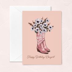 a pink card with boots and flowers on the bottom reads, happy birthday carolie