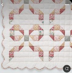 a quilted table topper with an arrow design on the front and back side