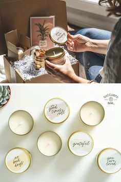 candles are sitting on a table next to boxes with cards and other items in them