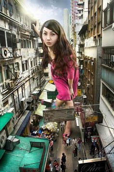 a woman standing on top of a building next to other buildings and people walking down the street