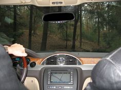 the interior of a car with trees in the background