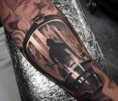 a man's arm with a lantern tattoo on it and a bear inside the lantern