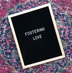 a black and white sign that says fostering love