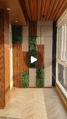 the inside of a building with wood paneling and plants on the wall, next to a large window