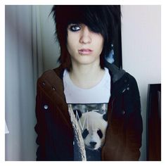 a woman with black hair and panda t - shirt in front of a mirror looking at the camera