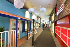 an empty hallway with red and blue walls