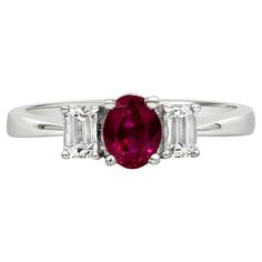 A beautiful three-stone engagement ring style, showcasing a 0.79 carat oval cut ruby, set on a four prong basket. Flanked by emerald cut diamonds weighing 0.41 carat total. Made with 18K white gold. Size 6.5 US, resizable upon request. Roman Malakov is a custom house, specializing in creating anything you can imagine. If you would like to receive a special quote on a custom piece, please message or call us. Luxury Ruby Three Stone Rings, Luxury Vintage Three Stone Ruby Ring, Vintage Oval Three-stone Ruby Ring, Red Three-stone Ruby Ring, Luxury Oval Three-stone Ruby Ring, Three Stone Engagement, Ruby Diamond, Three Stone Engagement Rings, Engagement Ring Styles