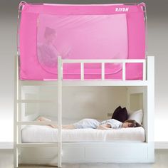 two people laying on top of a bunk bed with pink sheet over it and an open window to the side