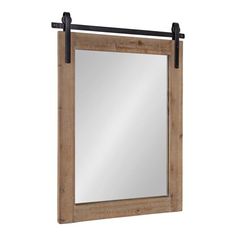 a mirror hanging on the wall with a black metal bar around it and a wooden frame