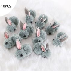 a group of stuffed rabbits sitting on top of a white fur covered floor