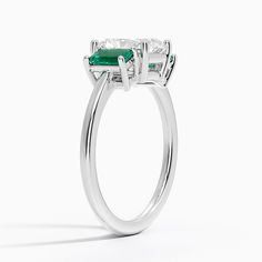 Radiant Cut Luxe Rhiannon Three Stone Lab Emerald Engagement Ring - 18K White Gold. Two luxurious lab emeralds rest alongside the center gemstone in this classic, sophisticated ring. Emerald Ring With Prong Setting And Radiant Cut, Radiant Cut Rings With Center Stone For May Birthstone, Classic Halo Ring With Brilliant Cut For May Birthstone, Fine Jewelry Radiant Cut Emerald Anniversary Ring, Classic Platinum Emerald Ring For May Birthstone, Classic Moissanite Emerald Ring For May Birthstone, Platinum Emerald-cut Diamond Ring For May Birthstone, Gia Certified Radiant Cut May Birthstone Rings, Gia Certified Radiant Cut Ring For May Birthstone