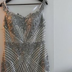 Terani Couture Sequined Gown. Size 9/10. I Wear A Street Size 8/10. This Dress Was Worn Once For My Daughter's Wedding. I Did Have The Length Altered. I Am 5'6. I Wore Platform Heels That Makes Me Around 5' 10. This Beautiful Dress Is All Beaded. I Will Be Happy To Answer Any Questions. I Was Told Only A Few Were Made. Embellished Ball Gown With Fitted Bodice For Evening, Silver Elegant Ball Gown Evening Dress, Elegant Silver Ball Gown Evening Dress, Elegant Silver Fitted Ball Gown, Silver Wedding Dress With Sweetheart Neckline, Silver Evening Dress With Sweetheart Neckline And Fitted Bodice, Elegant Fitted Silver Ball Gown, Wedding Evening Dress With Sequins And Sweetheart Neckline, Elegant Embellished Ball Gown With Sweetheart Neckline