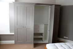 an empty bedroom with white closets and gray walls