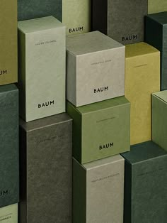 many different boxes are stacked on top of each other with the word baum printed on them