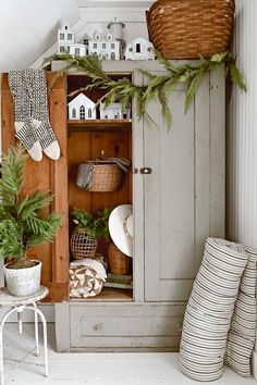 an old cupboard is decorated with greenery and other things to decorate in the room