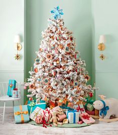 a white christmas tree surrounded by presents