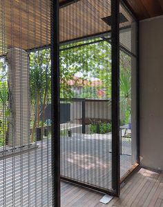 the inside of a room with wooden flooring and metal partitions on one side