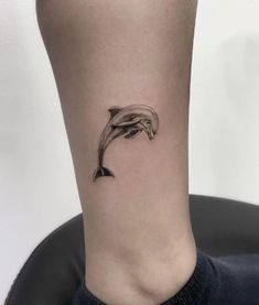 a small dolphin tattoo on the ankle