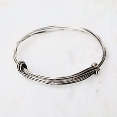 BRC Elephant Hair Inspired Bangle - Oxidized Sterling Silver - 7 Lines Everyday Metal Bracelets With Sliding Knot, Modern Twist Everyday Bracelet, Modern Twist Everyday Bracelet Jewelry, Everyday Hand Wrapped Bangle Bracelet, Adjustable Bracelet With A Modern Twist, Everyday Stackable Bangle, Silver Bangle Bracelet With Sliding Knot, Silver Sliding Knot Bangle Bracelets, Silver Sliding Knot Bangle Bracelet