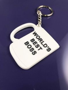 a bottle shaped keychain with the words world's best boss on it