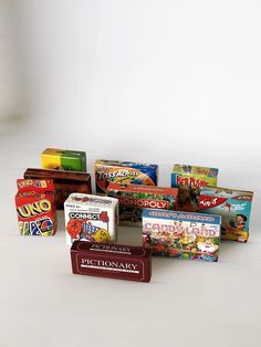 several different types of candy on a white surface with one box in the foreground