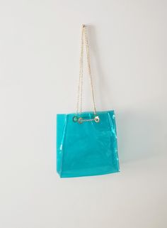 "Vinyl tote bag, everyday bag, beach an swimming pool, jelly bag, chain handbags, glamorous purse, turquoise gold or custom color, stadium Standard Shipping = Express Shipping by Fedex Made for order in 7 days. Dimensions: 30 x 30 x 10 cm / 12\" x12\" x 3,93\" Made of thick, crystalline, flexible PVC with big silver or gold toned chain (steel) A large handbag city , type of shopper . The modern concept of boho style , oversize . Large transparent BAG with large , solid chain referring to my fasc Trendy Turquoise Shoulder Bag For Daily Use, Blue Plastic Bags For Summer, Summer Clear Rectangular Bags, Blue Plastic Bag For Summer, Gold Beach Bag With Chain Strap, Clear Shoulder Bag For Beach, Trendy Turquoise Rectangular Shoulder Bag, Trendy Turquoise Shoulder Bag, Blue Shoulder Bag With Clear Strap For Daily Use