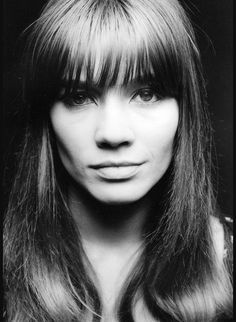 a black and white photo of a woman with long hair, bangs and fringes