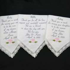 three personalized handkerchiefs with pink roses on them and the names of their guests