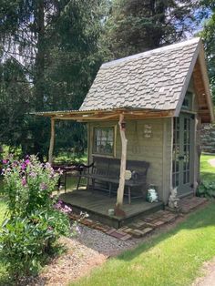 a small wooden cabin in the middle of some flowers