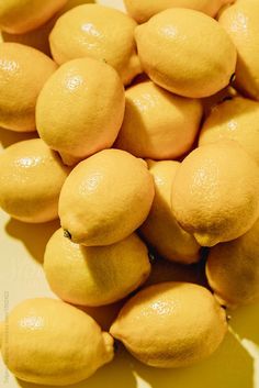 a pile of lemons sitting on top of a table