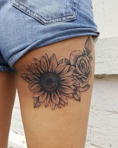 a sunflower tattoo on the back of a woman's thigh