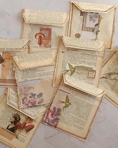 many old papers are stacked on top of each other with birds and flowers in them