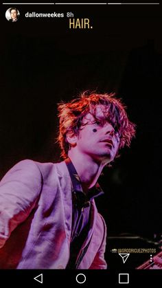 a man playing a bass in front of a black background with the words hair on it