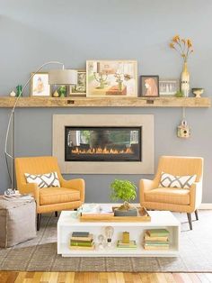 a living room filled with furniture and a fire place in the middle of the room