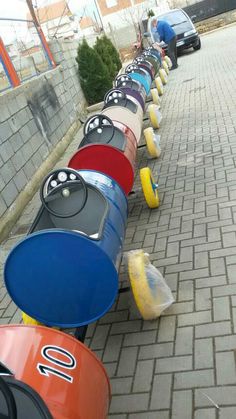 a row of colorfully painted fire hydrants sitting on the side of a road