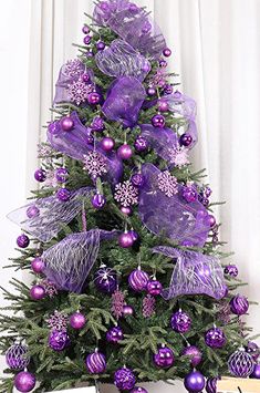 a purple christmas tree decorated with ornaments